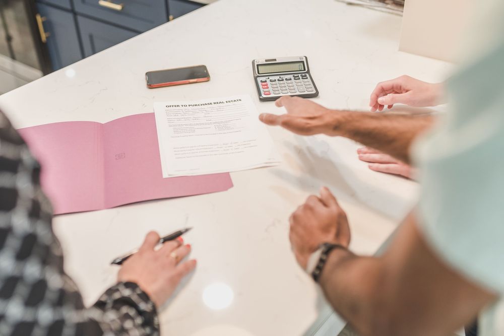 Échange autour d'un dossier de création, calculatrice sur la table
